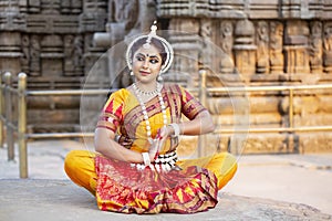 Odissi Dancer wears traditional costume posing at konark temple. Indian traditional girl.