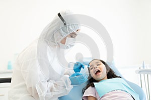 Odontologist In Protective Workwear Examining Patient