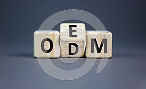 OEM or ODM symbol. Concept word OEM ODM original design equipment manufactirer on wooden block. Beautiful grey table grey