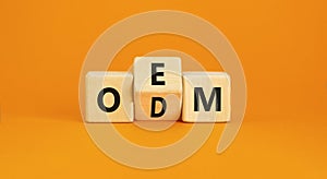 OEM or ODM symbol. Concept word OEM ODM original design equipment manufactirer on wooden block. Beautiful orange table orange