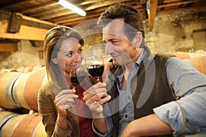 Oenologists tasting red wine