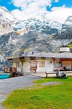 Oeschinnensee lake, wooden chalet, Switzerland.