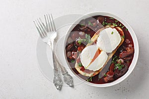 Oeufs en meurette is a classic French dish of poached eggs covered in a rich red wine sauce filled with lardons, mushrooms and