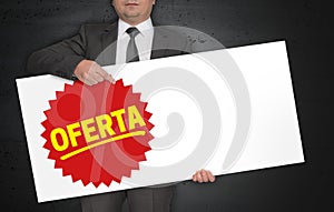 Oferta poster is held by businessman photo