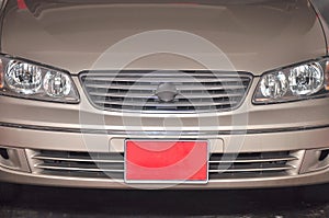 An off-peak vehicle license plate which is red in color