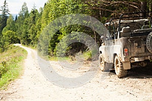 Off road 4x4 adventure, jeep on mountain dirt road. Copy space for text