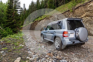 Off-road 4x4 car driving on a narrow gravel road to Zekari Pass (Meskheti Range), Georgia