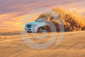 Off-road adventure with SUV in Arabian Desert at sunset. Visit Dubai.