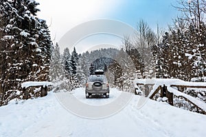 Off Road Adventure in Winter Snow Covered Wilderness Forest. 4x4 Icy Road Driving