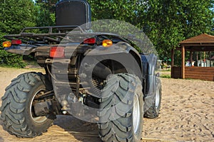 Off-road ATV on the sandy beach of the sea, quad bike rides, active recreation, tourism