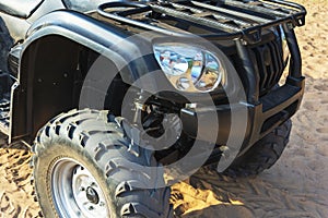 Off-road ATV on the sandy beach of the sea, quad bike rides, active recreation, tourism