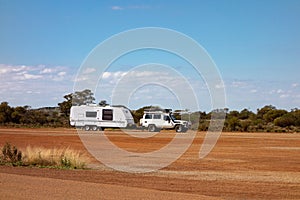 Off road car with air intakes and a white caravan trailer in Western Australia