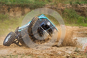 Off-road car crossing mud obstacle