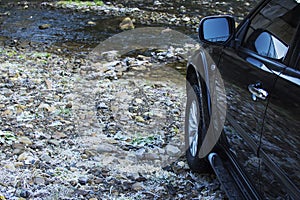 Off-road car driving mountain river