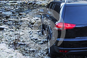 Off-road car driving mountain river