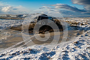 Off road car on mountain road. Travel concept with big 4x4 car. Extreme. A car sprays mud. Surmounting the wild area photo