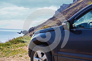 off-road car moves along a dirt mountain road