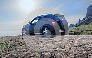 Off-road Car Moves along a dirt mountain road