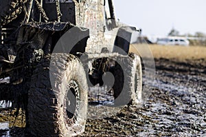 Off-road car in a puddle making mud splashes.