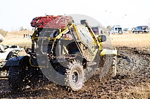 Off-road car in a puddle making mud splashes.