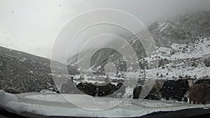 Off road car running on snowing mountain trail