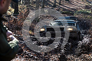 Off road car. Scene mud splash in off-road racing. Wheel in deep rut goes through mud and leaves trail. Off-road travel