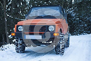 off road car with snow chains in winter