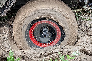 Off road car stuck in deep mud.