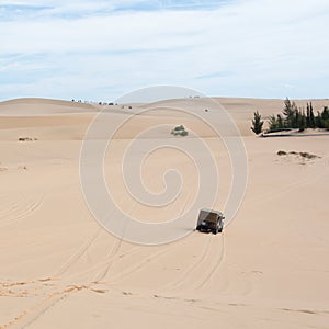 Off road car vehicle in white sand dune desert