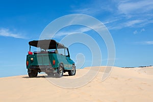 Off road car vehicle in white sand dune desert at Mui Ne