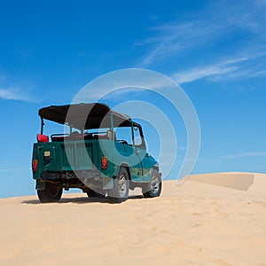 Off road car vehicle in white sand dune desert at Mui Ne