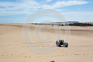 Off road car vehicle in white sand dune desert at Mui Ne