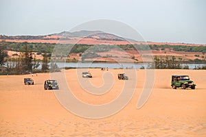 Off road car vehicle in white sand dune desert at Mui Ne