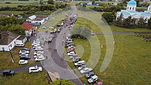 Off-road competition. SUV cars parking at meeting point before challenge. Aerial view.