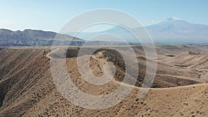 Off road on desert mountains. Ararat mountain background.