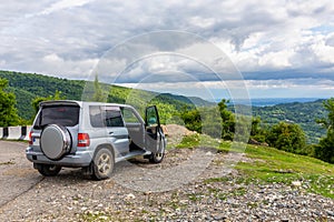 Off-road in Georgia, 4x4 car on a gravel road towards Khvamli Mountain peak, Georgia