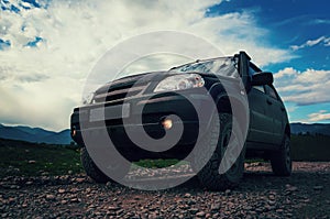 Off-road Jeep car on bad gravel road