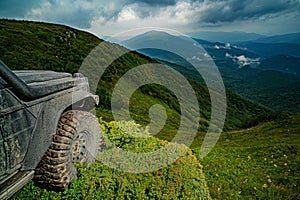 Off-road Jeep car on bad gravel road. Off-road travel on mountain. Offroad car on bad road.