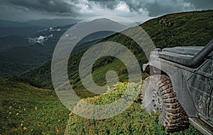 Off-road Jeep car on bad gravel road. Off-road travel on mountain. Offroad car on bad road.