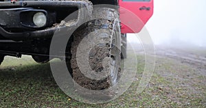 Off-road racing and dirty jeep wheel. closeup