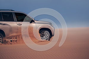 Off-road safari on the golden sands of the desert on a car in Walvis Bay. Namibia.