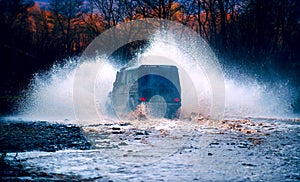 Off road. Suv splash on the river outdoor, traveling on the road. cene of mud splash in off-road racing. Stop action