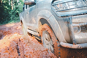 Off-road tires, Dirty offroad car, SUV covered with mud on countryside road.  offroad travel  and driving concept