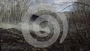 Off-road truck tire dirty with wet and dry mud with rim. Dirty wheel tires in mud. Mud and water splash in off-road