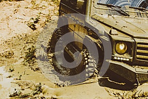 Off-road vehicle goes on the mountain. 4x4 travel trekking. Offroad vehicle coming out of a mud hole hazard. Jeep