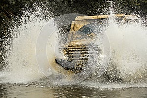 Off-road vehicle goes on the mountain. Tires in preparation for race. Expedition offroader. Jeep outdoors adventures