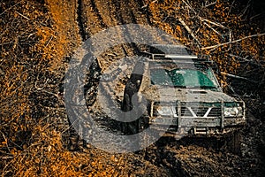 Off-road vehicle goes on mountain way. Motion the wheels tires and off-road that goes in the dust on the sand