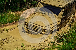 Off-road vehicle goes on mountain way. Tires in preparation for race. Safari suv. Jeep outdoors adventures. Mudding is
