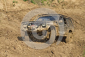 Off-road vehicle in muddy terrain.