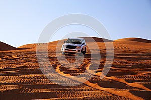 Off road vehicle on sand dunes, Oman